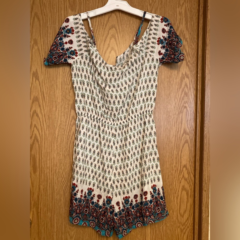 A multicolored romper that is kinda off the shoulder from Spiaggua dolce. M